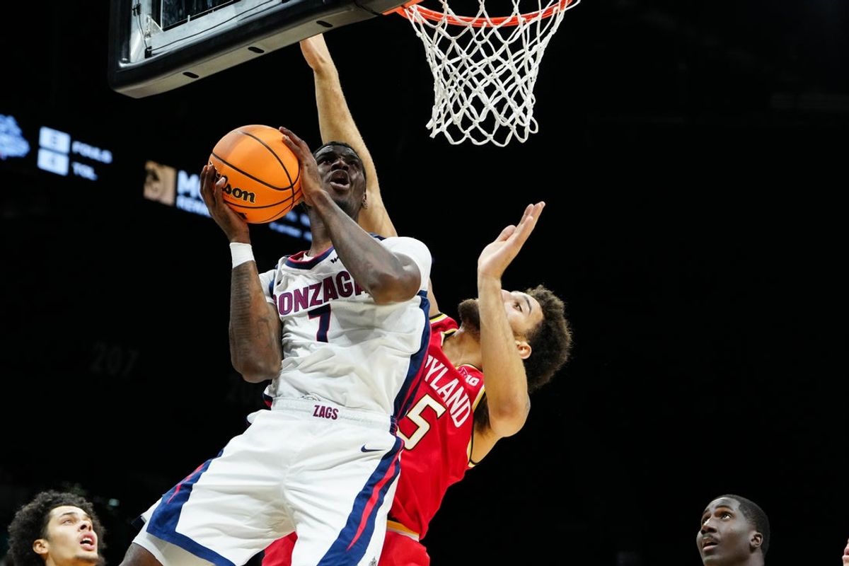 Nov 25, 2025; Las Vegas, NV, USA; Gonzaga Bulldogs guard Tyon Grant-Foster (7) drives past Maryland Terrapins center Collin Metcalf (45) in the first half in a 2025 Players Era Festival group play game at MGM Grand Garden Arena. Mandatory Credit: Stephen R. Sylvanie-Imagn Images
