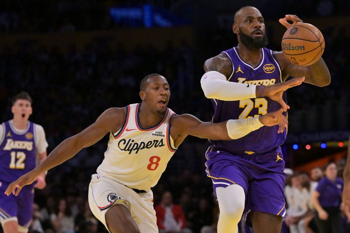 Nov 25, 2025; Los Angeles, California, USA;  Los Angeles Lakers forward LeBron James (23) drives past Los Angeles Clippers guard Kris Dunn (8) during the first half at Crypto.com Arena. Mandatory Credit: Jayne Kamin-Oncea-Imagn Images