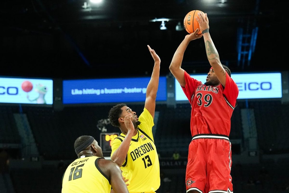 Nov 25, 2025; Las Vegas, Nevada, USA; San Diego State Aztecs guard Reese Dixon-Waters (39) shoot while defended by Oregon Ducks forward Sean Stewart (13) in the second half in a 2025 Players Era Festival group play game at Michelob Ultra Arena. Mandatory Credit: Kirby Lee-Imagn Images