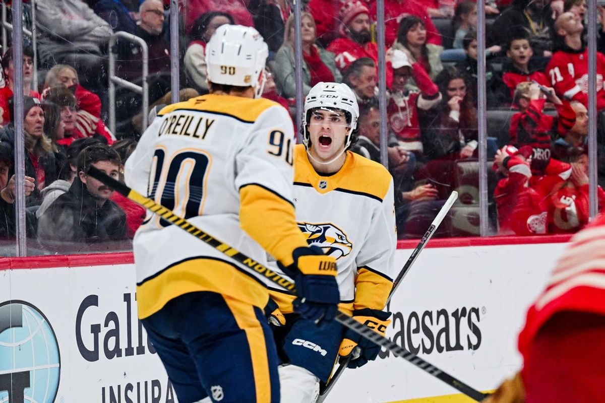 Nov 26, 2025; Detroit, Michigan, USA; Nashville Predators center Ryan O'Reilly (90) celebrates his goal with right wing Luke Evangelista (77) during the third period against the Detroit Red Wings at Little Caesars Arena. Mandatory Credit: Tim Fuller-Imagn Images