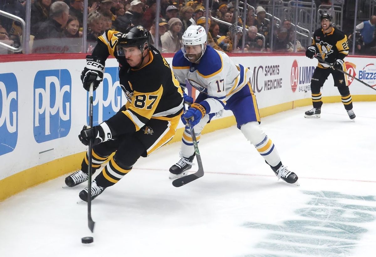 Nov 26, 2025; Pittsburgh, Pennsylvania, USA; Pittsburgh Penguins center Sydney Crosby (87) moves the puck against Buffalo Sabres left wing Jason Zucker (17) during the second period at PPG Paints Arena. Mandatory Credit: Charles LeClaire-Imagn Images