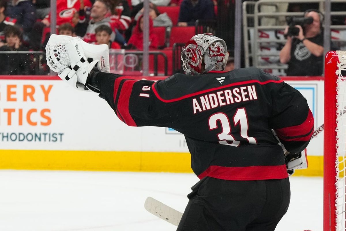 Nov 15, 2025; Raleigh, North Carolina, USA; Carolina Hurricanes goaltender Frederik Andersen (31) reaches out to make a glove save against the New York Rangers during the second period at Lenovo Center. Mandatory Credit: James Guillory-Imagn Images