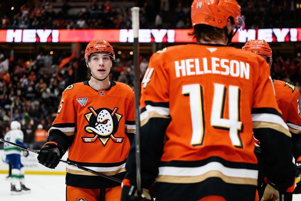 Nov 26, 2025; Anaheim, California, USA; Anaheim Ducks right wing Beckett Sennecke (45), left, looks on after assisting on a goal during the second period against the Vancouver Canucks at Honda Center. Mandatory Credit: William Liang-Imagn Images