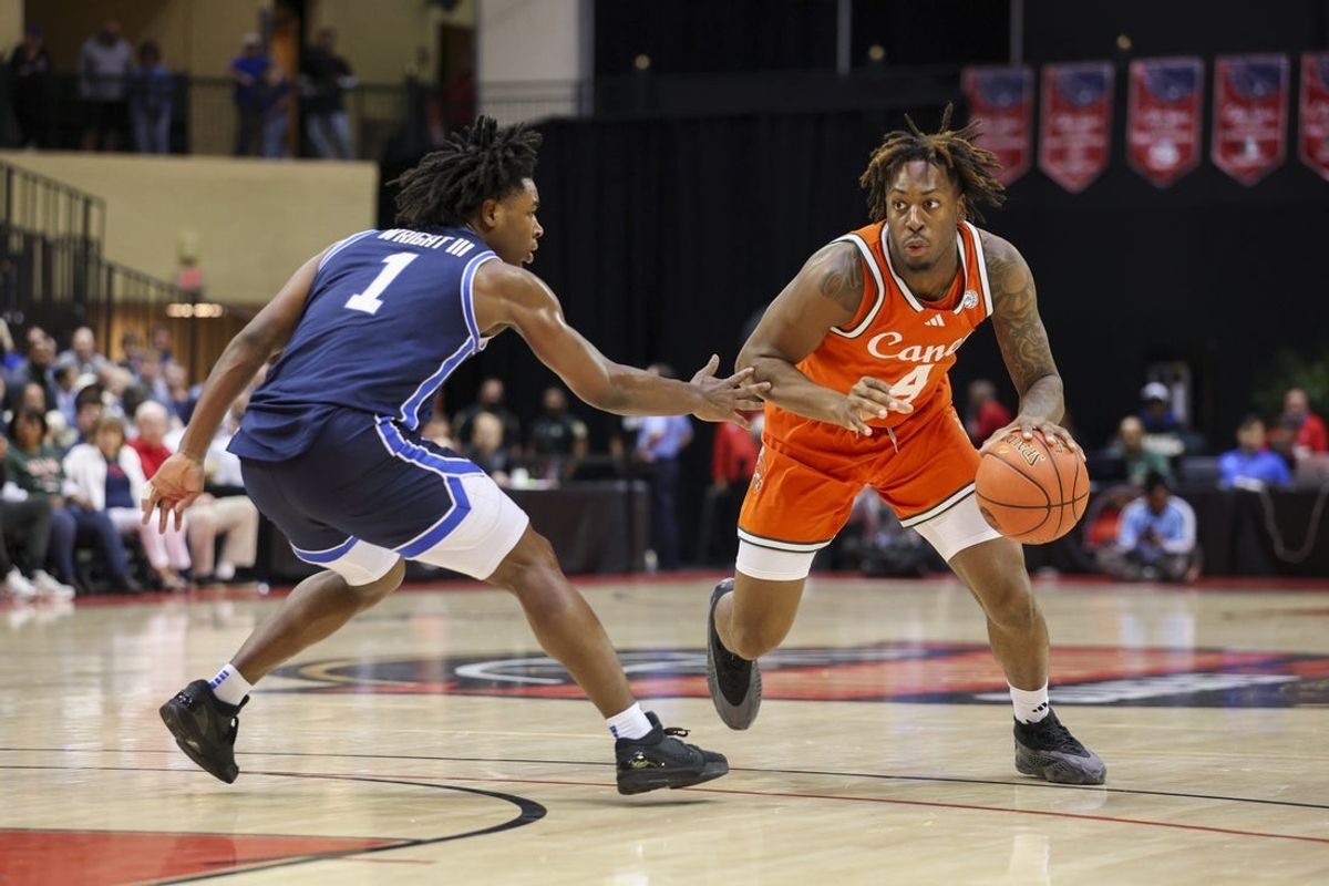 Nov 27, 2025; Kissimmee, Florida, USA; Miami (FL) Hurricanes guard Marcus Allen (4) is guarded by Brigham Young University Cougars guard Robert Wright III (1) in the first half at State Farm Field House. Mandatory Credit: Nathan Ray Seebeck-Imagn Images