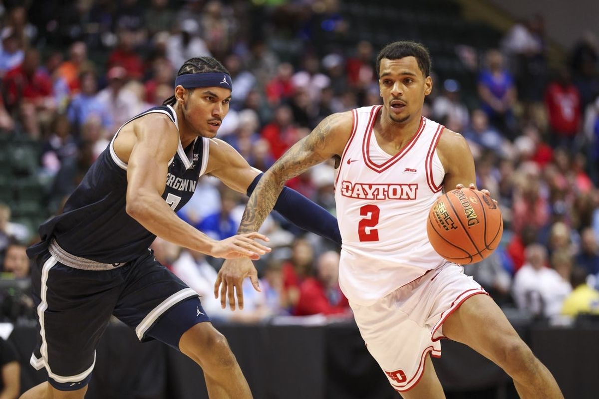 Nov 27, 2025; Kissimmee, Florida, USA; Dayton Flyers guard De'Shayne Montgomery (2) drives to the basket past Georgetown Hoyas forward Isaiah Abraham (7) in the first half at State Farm Field House. Mandatory Credit: Nathan Ray Seebeck-Imagn Images