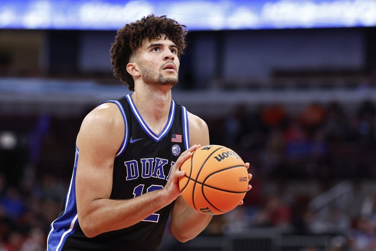 Nov 27, 2025; Chicago, Illinois, USA; Duke Blue Devils forward Cameron Boozer (12) shoots a free throw against the Arkansas Razorbacks during the second half at United Center. Mandatory Credit: Kamil Krzaczynski-Imagn Images