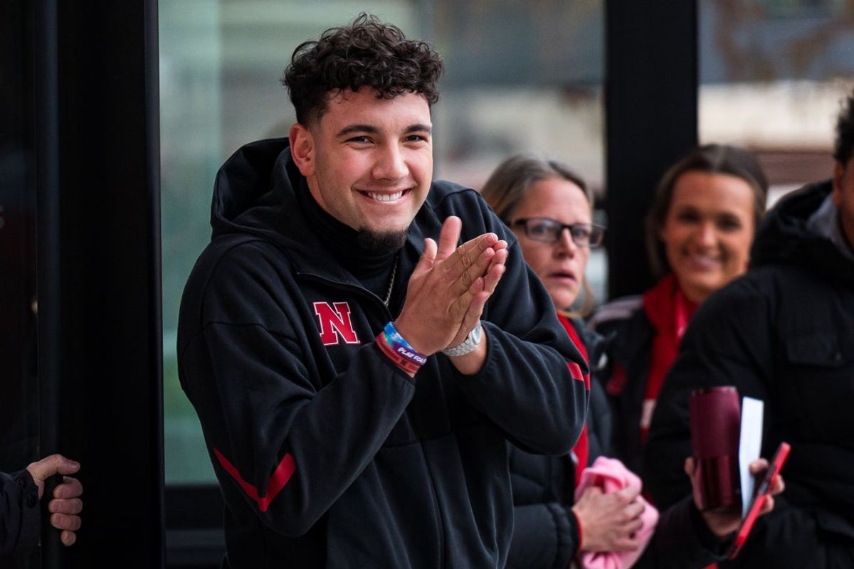Nov 28, 2025; Lincoln, Nebraska, USA; Nebraska Cornhuskers quarterback Dylan Raiola (15) greets the team as the walk into the stadium before the game against the Iowa Hawkeyes at Memorial Stadium. Mandatory Credit: Dylan Widger-Imagn Images