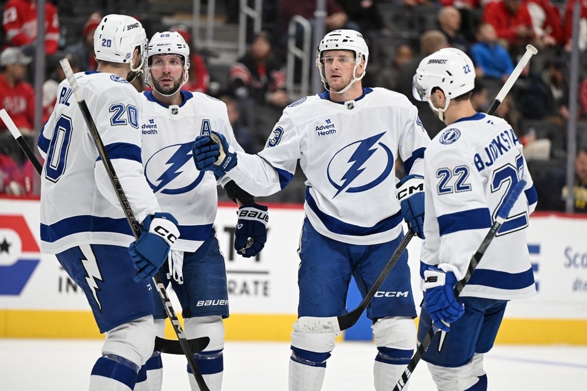 Nov 28, 2025; Detroit, Michigan, USA; Tampa Bay Lightning defenseman Darren Raddysh (43) celebrates his power play goal with teammates (from left) Nick Paul (20) Nikita Kucherov (86) and Oliver Bjorkstrand (22) against the Detroit Red Wings in the first period at Little Caesars Arena. Mandatory Credit: Lon Horwedel-Imagn Images