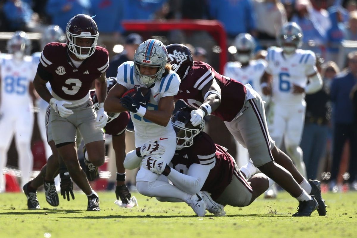 Nov 28, 2025; Starkville, Mississippi, USA; Mississippi Rebels wide receiver Cayden Lee (19) runs against Mississippi State Bulldogs defensive lineman Jamil Burroughs (88)  and linebacker Jalen Smith (10) in the first half at Davis Wade Stadium at Scott Field. Mandatory Credit: Petre Thomas-Imagn Images