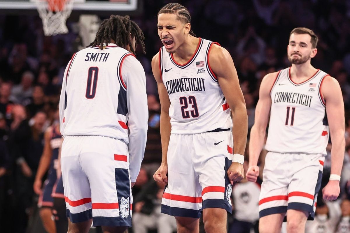 Nov 28, 2025; New York, New York, USA;  UConn Huskies forward Jayden Ross (23) celebrates with guard Malachi Smith (0) in the second half against the Illinois Fighting Illini at Madison Square Garden. Mandatory Credit: Wendell Cruz-Imagn Images