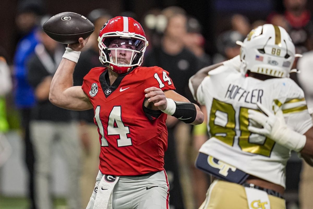 Nov 28, 2025; Atlanta, Georgia, USA; Georgia Bulldogs quarterback Gunner Stockton (14) passes the ball against the Georgia Tech Yellow Jackets during the first quarter at Mercedes-Benz Stadium. Mandatory Credit: Dale Zanine-Imagn Images