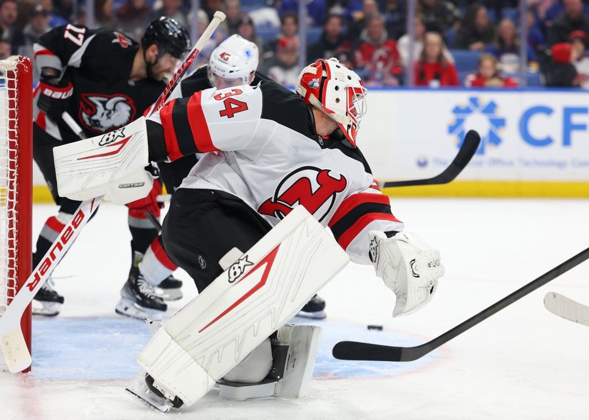 Nov 28, 2025; Buffalo, New York, USA;  New Jersey Devils goaltender Jake Allen (34) looks for the puck during the second period against the Buffalo Sabres at KeyBank Center. Mandatory Credit: Timothy T. Ludwig-Imagn Images