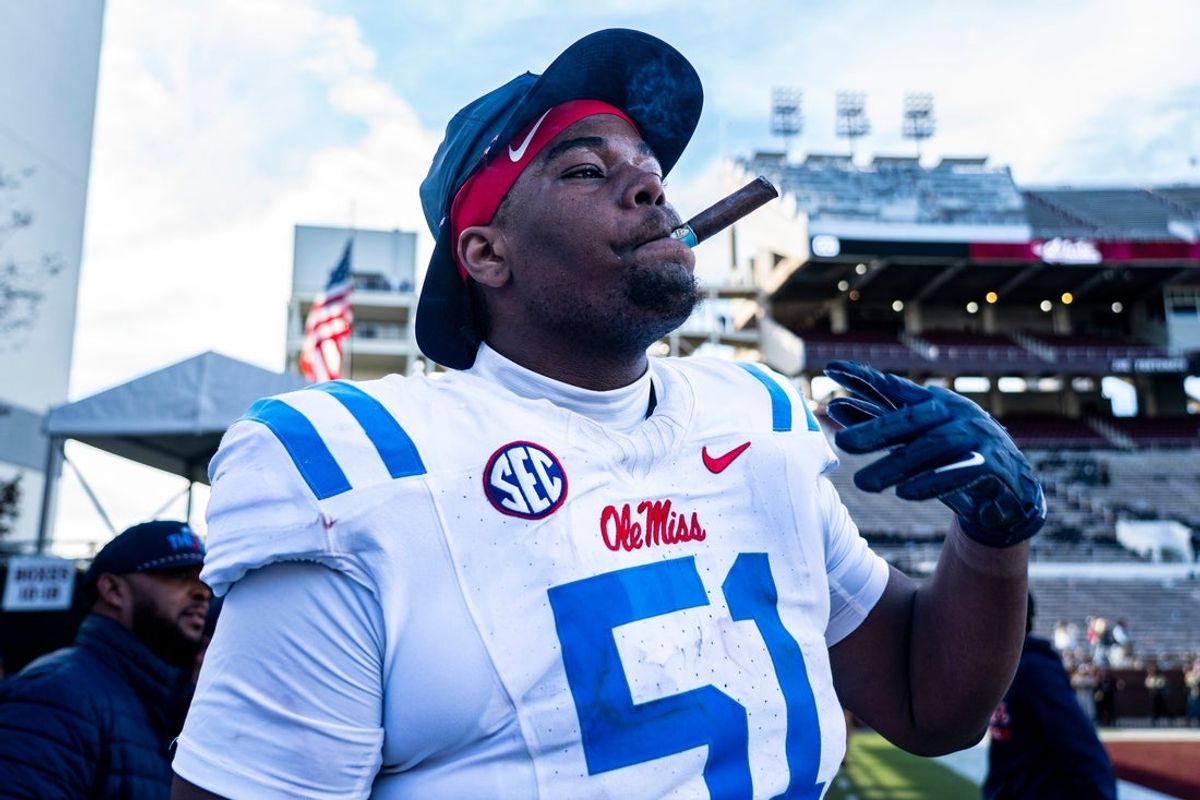 Ole Miss defensive lineman Zxavian Harris (51) smokes a cigar after a college football game between Mississippi State and Ole Miss at Davis Wade Stadium in Starkville, Miss., on Friday, Nov. 28, 2025. Ole Miss defeated Mississippi State 38-19 in the Egg Bowl.