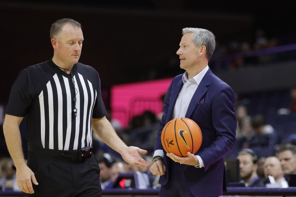 Nov 28, 2025; Charlottesville, Virginia, USA; Virginia Cavaliers head coach Ryan Odom holds the ball on the sidelines against the Queens University of Charlotte Royals during the second half at John Paul Jones Arena. Mandatory Credit: Amber Searls-Imagn Images
