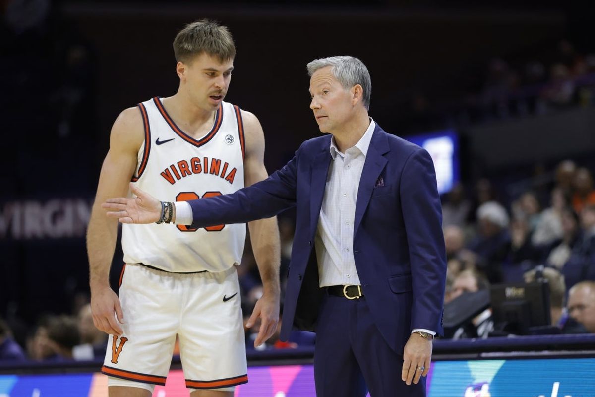 Nov 28, 2025; Charlottesville, Virginia, USA; Virginia Cavaliers head coach Ryan Odom (right) speaks to Cavaliers guard Dallin Hall (30) on the sidelines against the Queens University of Charlotte Royals during the second half at John Paul Jones Arena. Mandatory Credit: Amber Searls-Imagn Images