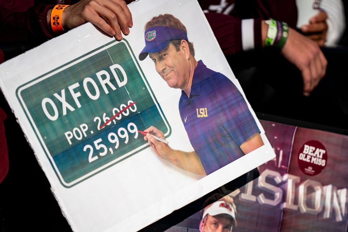 Mississippi State fans hold signs referencing Ole Miss head coach Lane Kiffin’s potential departure during a college football game between Mississippi State and Ole Miss at Davis Wade Stadium in Starkville, Miss., on Friday, Nov. 28, 2025. Ole Miss defeated Mississippi State 38-19 in the Egg Bowl.