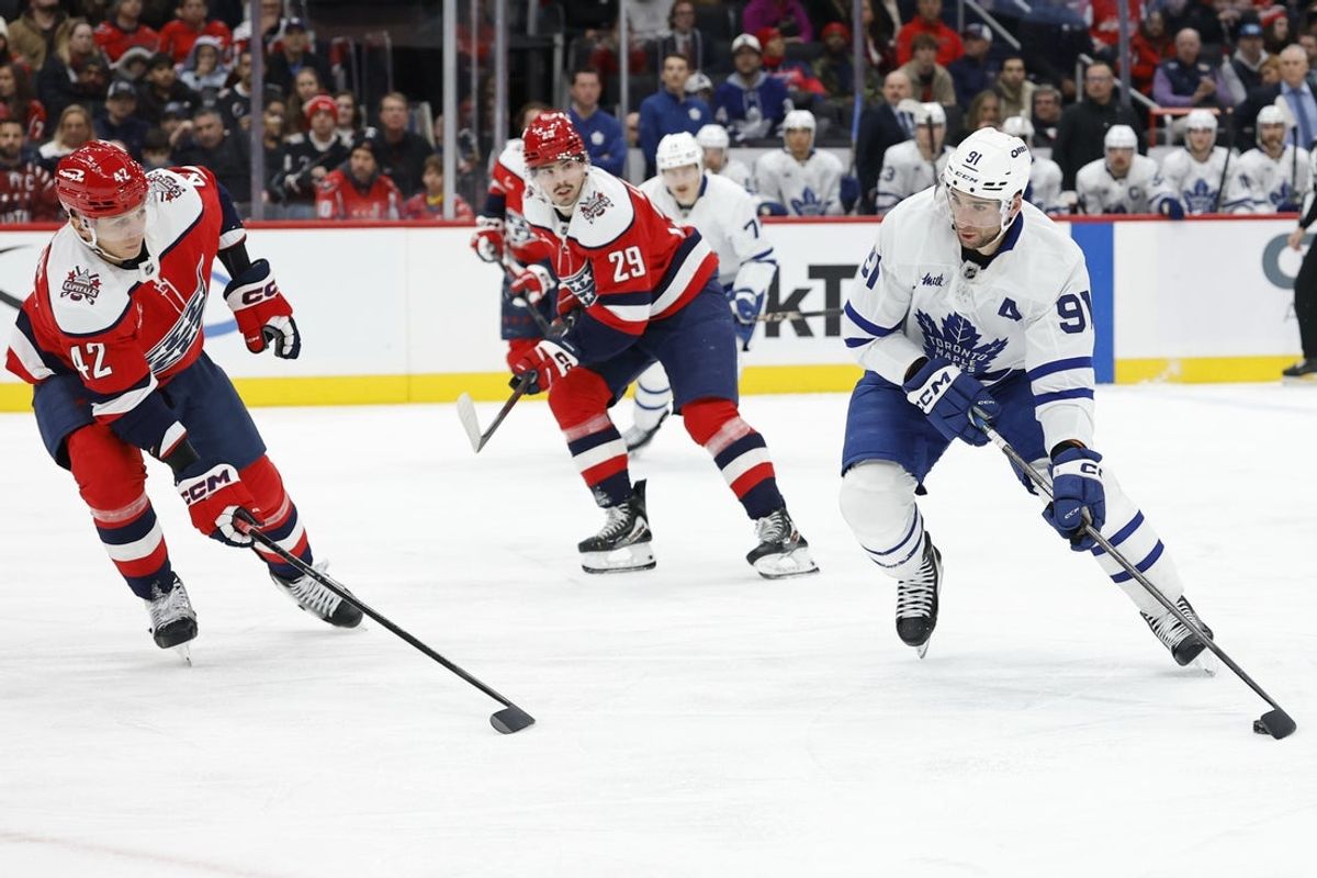 Nov 28, 2025; Washington, District of Columbia, USA; Toronto Maple Leafs center John Tavares (91) skates with the puck as Washington Capitals defenseman Martin Fehérváry (42) defends during the second period at Capital One Arena. Mandatory Credit: Geoff Burke-Imagn Images