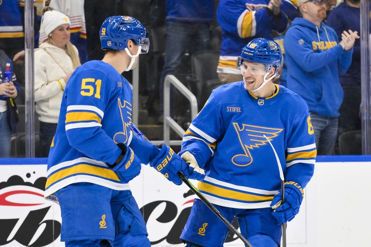Nov 28, 2025; St. Louis, Missouri, USA; St. Louis Blues defenseman Matthew Kessel (51) celebrates with left wing Dylan Holloway (81) after scoring against the Ottawa Senators during the third period at Enterprise Center. Mandatory Credit: Jeff Curry-Imagn Images