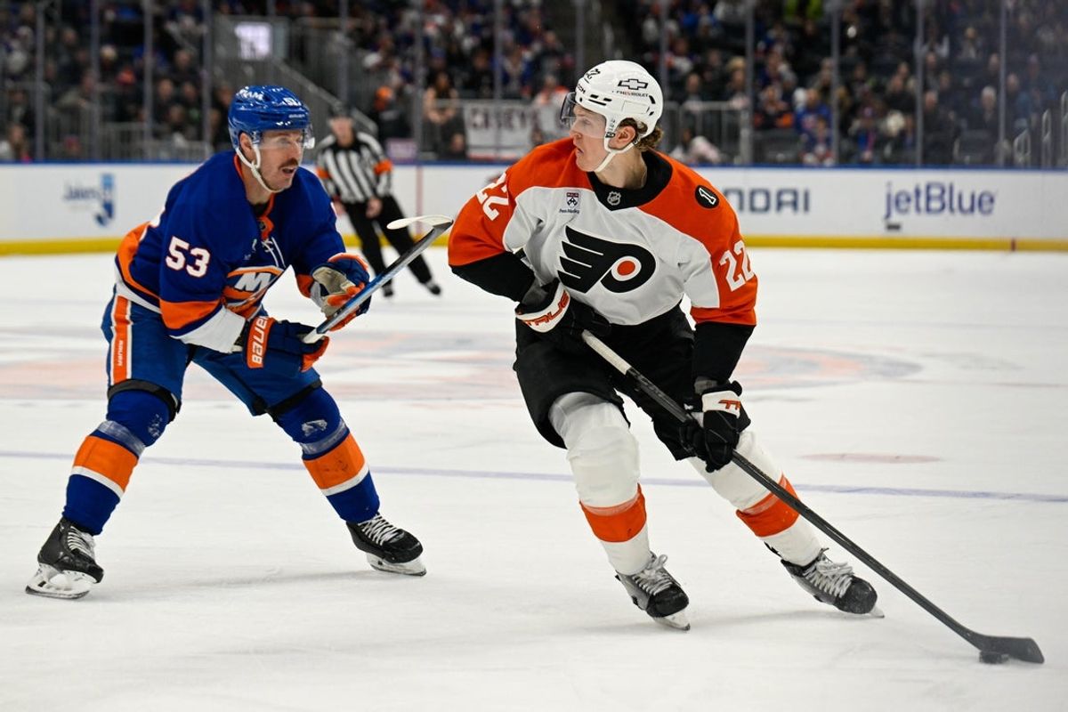 Nov 28, 2025; Elmont, New York, USA; New York Islanders center Casey Cizikas (53) defends against Philadelphia Flyers center Christian Dvorak (22) during the third period at UBS Arena. Mandatory Credit: Dennis Schneidler-Imagn Images
