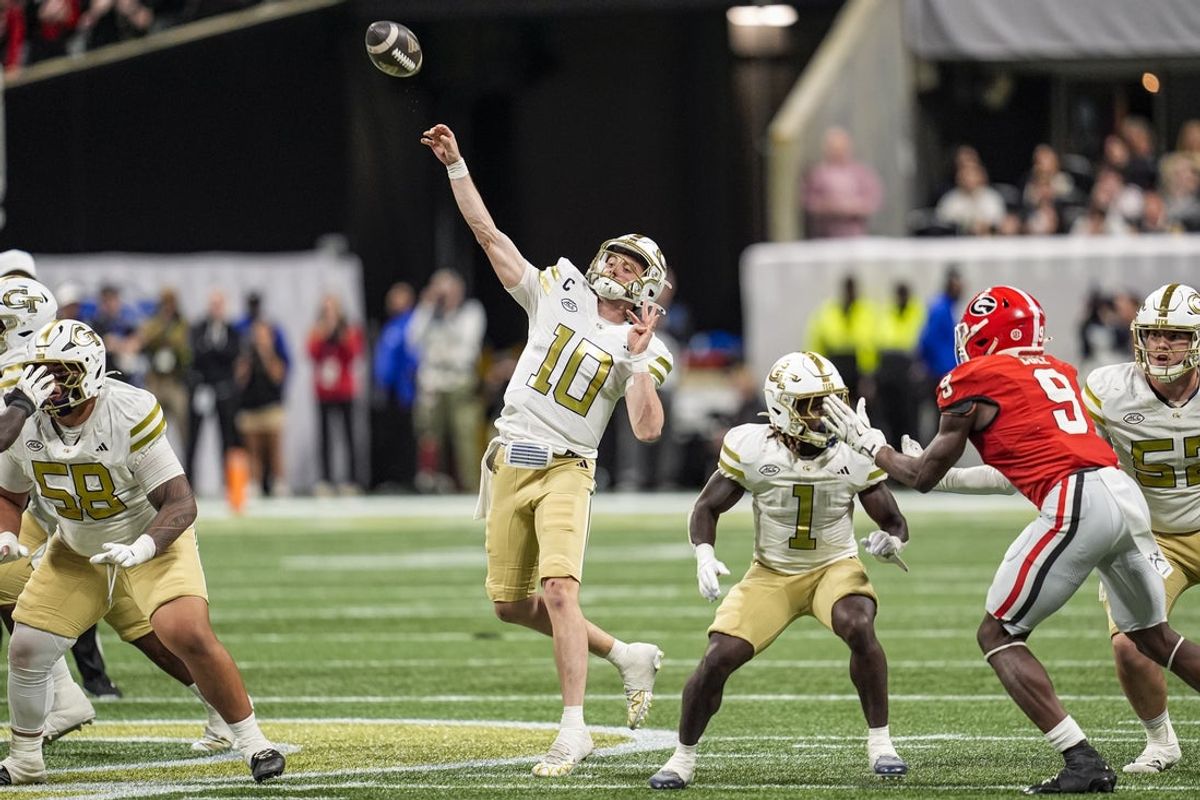 Nov 28, 2025; Atlanta, Georgia, USA; Georgia Tech Yellow Jackets quarterback Haynes King (10) throws a last chance pass to the end zone against the Georgia Bulldogs during the second half at Mercedes-Benz Stadium. Mandatory Credit: Dale Zanine-Imagn Images