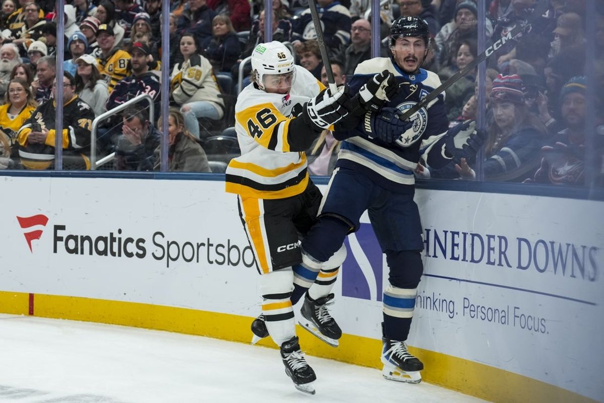 Nov 28, 2025; Columbus, Ohio, USA;  Pittsburgh Penguins center Blake Lizotte (46) checks Columbus Blue Jackets defenseman Zach Werenski (8) along the boards in the first period at Nationwide Arena. Mandatory Credit: Aaron Doster-Imagn Images