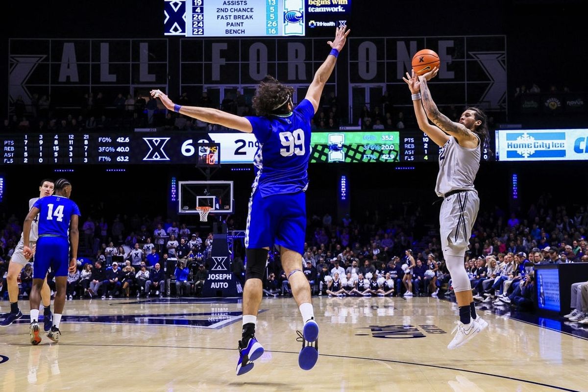 Nov 28, 2025; Cincinnati, Ohio, USA; Xavier Musketeers forward Tre Carroll (12) shoots against Texas A&M-Corpus Christi Islanders forward Cenker Evran (99) in the second half at Cintas Center. Mandatory Credit: Katie Stratman-Imagn Images