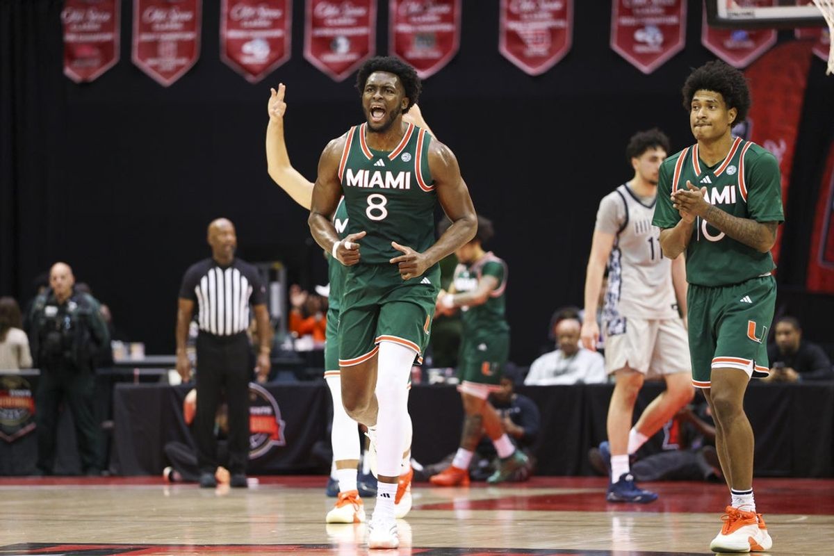 Nov 28, 2025; Kissimmee, FL, USA; Miami (FL) Hurricanes center Ernest Udeh Jr. (8) reacts after a basket against the Georgetown Hoyas in the first half during the ESPN Events Invitational at State Farm Field House. Mandatory Credit: Nathan Ray Seebeck-Imagn Images