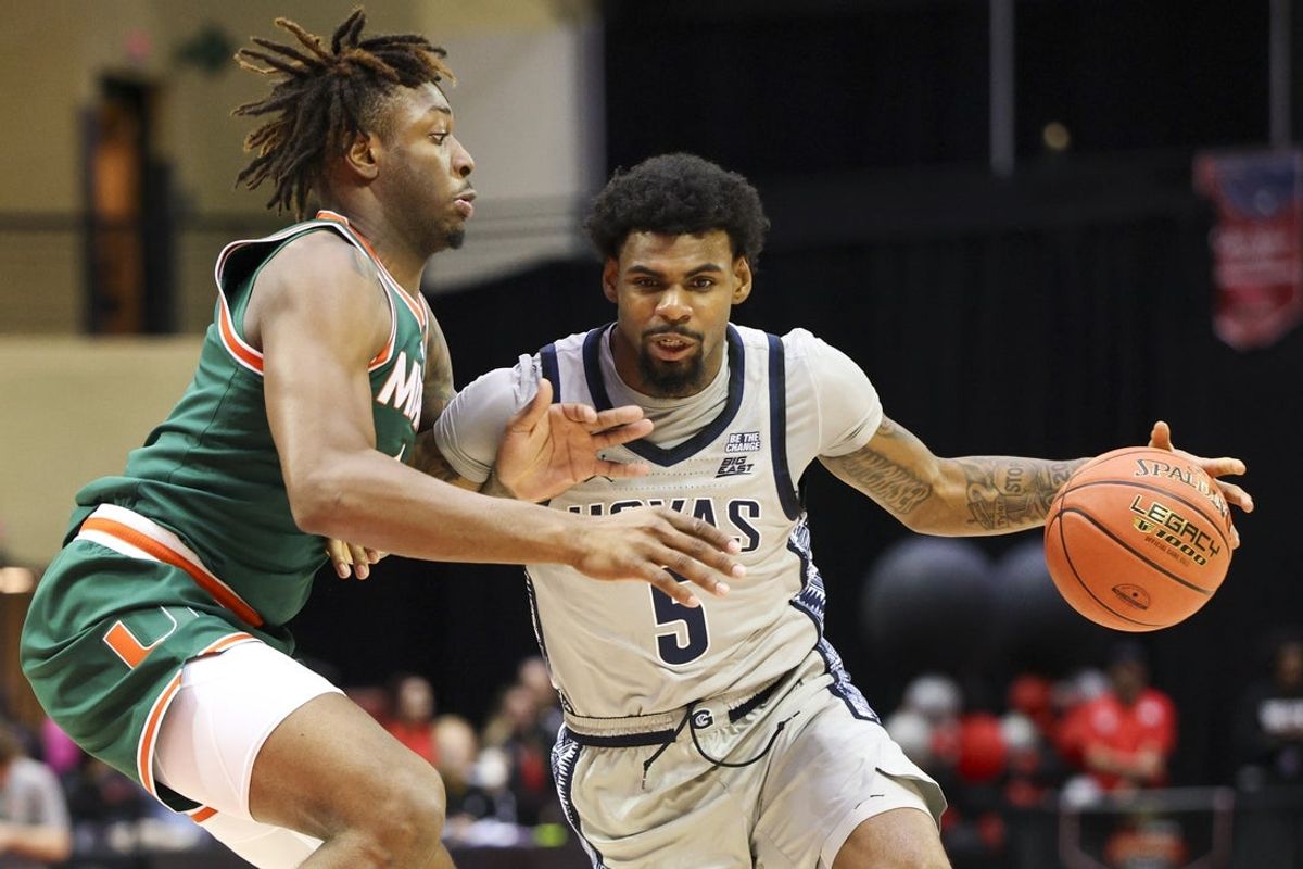 Nov 28, 2025; Kissimmee, FL, USA; Georgetown Hoyas guard Kj Lewis (5) is guarded by Miami (FL) Hurricanes guard Marcus Allen (4) in the first half during the ESPN Events Invitational at State Farm Field House. Mandatory Credit: Nathan Ray Seebeck-Imagn Images