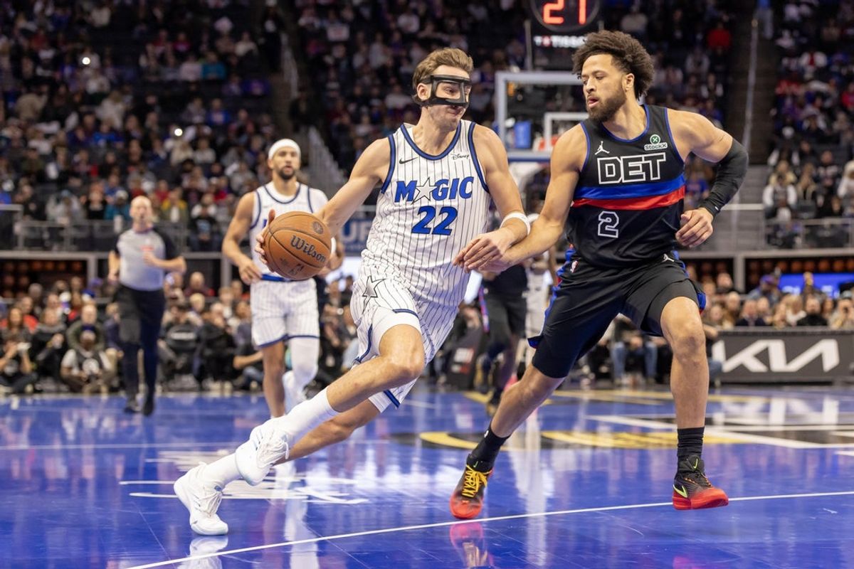Nov 28, 2025; Detroit, Michigan, USA; Orlando Magic forward Franz Wagner (22) drives to the basket as Detroit Pistons guard Cade Cunningham (2) defends during the first quarter at Little Caesars Arena. Mandatory Credit: David Reginek-Imagn Images
