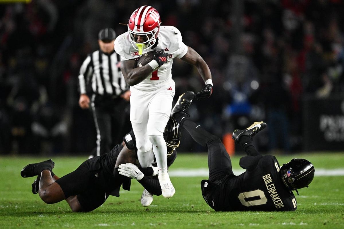 Nov 28, 2025; West Lafayette, Indiana, USA; Indiana Hoosiers running back Roman Hemby (1) breaks a tackle from Purdue Boilermakers defensive back Tony Grimes (0) during the second quarter at Ross-Ade Stadium. Mandatory Credit: Marc Lebryk-Imagn Images