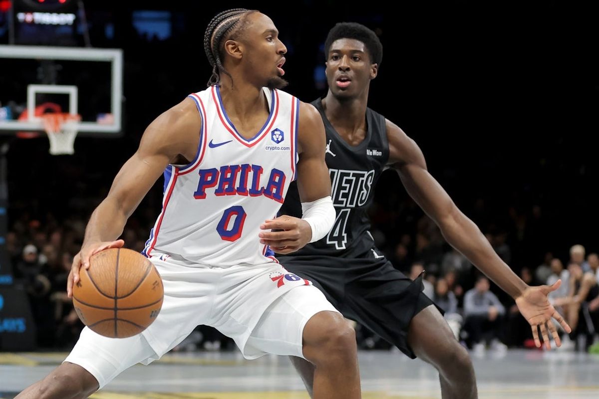 Nov 28, 2025; Brooklyn, New York, USA; Philadelphia 76ers guard Tyrese Maxey (0) controls the ball against Brooklyn Nets guard Drake Powell (4) during the second quarter at Barclays Center. Mandatory Credit: Brad Penner-Imagn Images