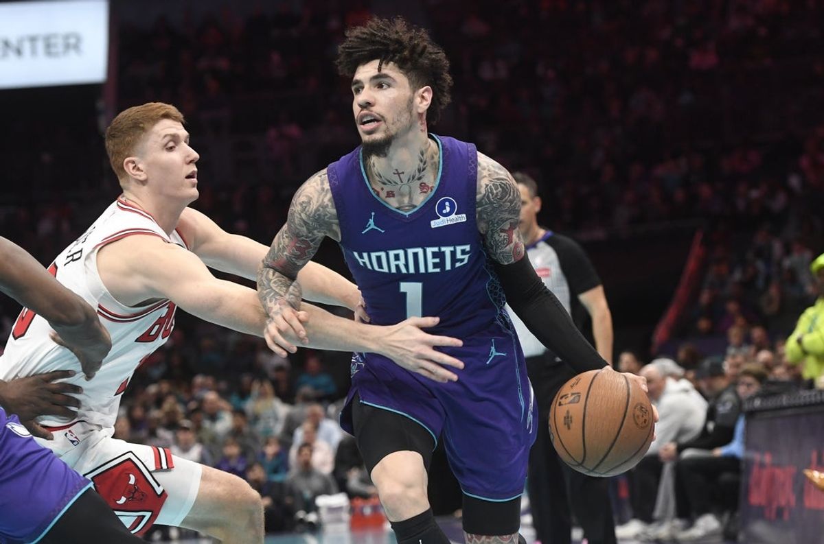 Nov 28, 2025; Charlotte, North Carolina, USA; Charlotte Hornets guard LaMelo Ball (1) drives past Chicago Bulls guard Kevin Huerter (13) during the first half at the Spectrum Center. Mandatory Credit: Sam Sharpe-Imagn Images