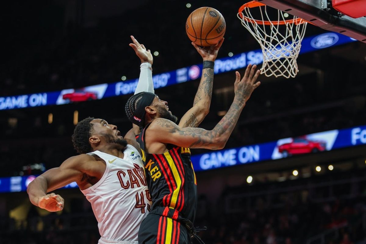 Nov 28, 2025; Atlanta, Georgia, USA; Atlanta Hawks guard Nickeil Alexander-Walker (7) shoots the ball against Cleveland Cavaliers guard Donovan Mitchell (45) during the first quarter at State Farm Arena. Mandatory Credit: Jordan Godfree-Imagn Images