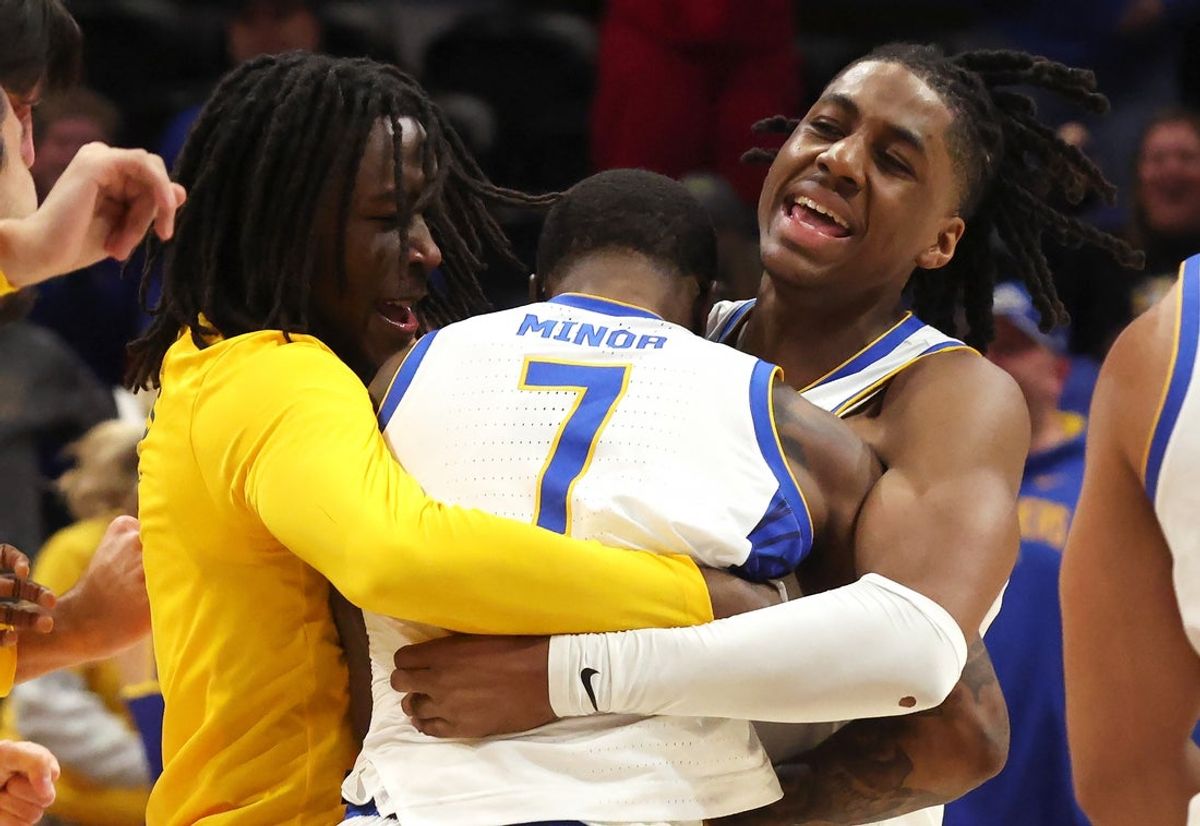 Nov 28, 2025; Pittsburgh, Pennsylvania, USA;  Pittsburgh Panthers guard Macari Moore (left) and guard Omari Witherspoon (right) celebrate with guard Damarco Minor (7) after Minor made a game winning three-point basket to defeat the Ohio State Buckeyes at the Petersen Events Center. Mandatory Credit: Charles LeClaire-Imagn Images