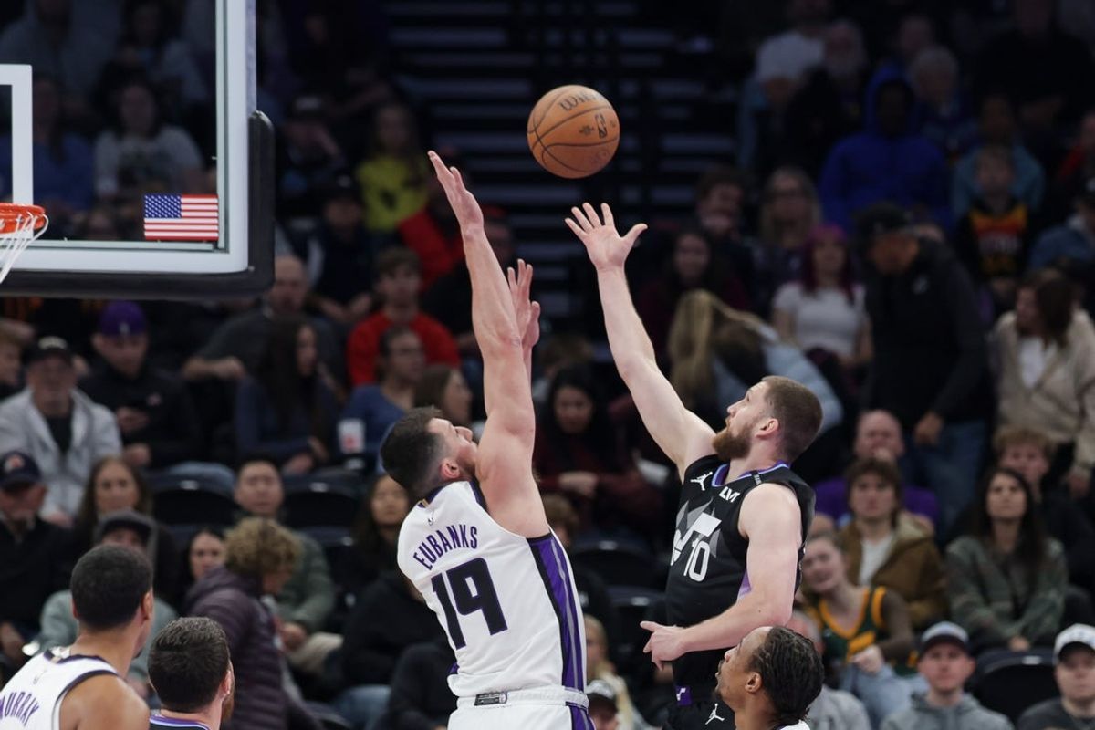 Nov 28, 2025; Salt Lake City, Utah, USA; Utah Jazz guard Svi Mykhailiuk (10) puts the ball over the arms of Sacramento Kings forward Drew Eubanks (19) during the first quarter at Delta Center. Mandatory Credit: Chris Nicoll-Imagn Images