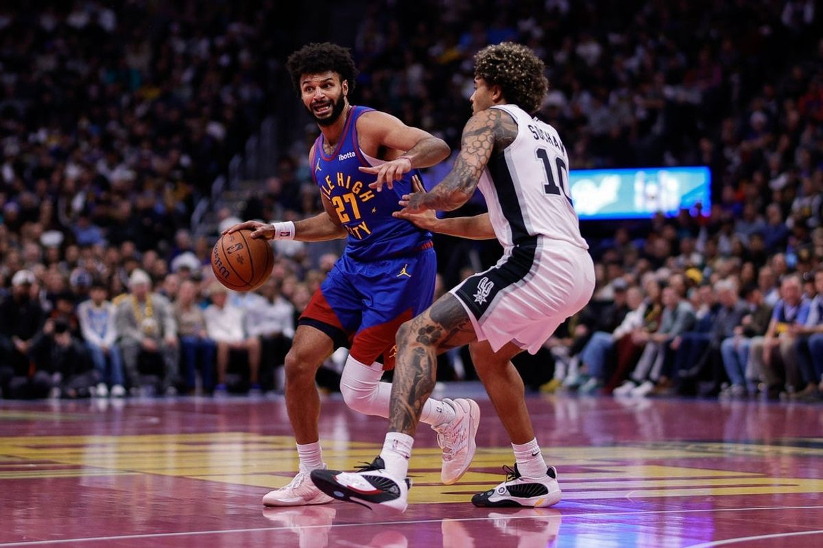 Nov 28, 2025; Denver, Colorado, USA; Denver Nuggets guard Jamal Murray (27) controls the ball as San Antonio Spurs forward Jeremy Sochan (10) guards in the second quarter at Ball Arena. Mandatory Credit: Isaiah J. Downing-Imagn Images