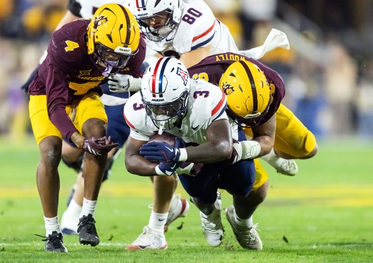 Nov 28, 2025; Tempe, Arizona, USA; Arizona Wildcats running back Kedrick Reescano (3) is tackled by Arizona State Sun Devils defensive lineman Justin Wodtly (95) in the first half during the 99th Territorial Cup at Mountain America Stadium. Mandatory Credit: Mark J. Rebilas-Imagn Images