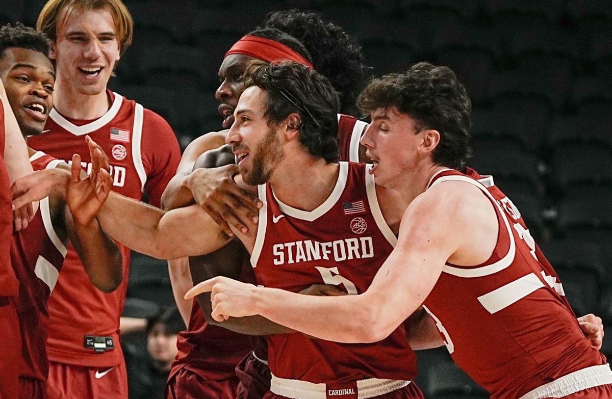 Benny Gealer, center #5, is mobbed by his teammates after making a three-pointer with .08 seconds left to give Stanford the win over St. Louis University in the Acrisure Invitational Champioship game at Acrisure Arena in Palm Desert, Calif., Nov. 28, 2025.