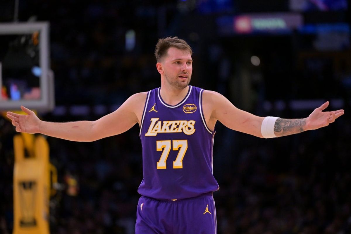Nov 28, 2025; Los Angeles, California, USA;  Los Angeles Lakers guard Luka Doncic (77) reacts after a foul on Dallas Mavericks forward Naji Marshall (13) in the second half at Crypto.com Arena. Mandatory Credit: Jayne Kamin-Oncea-Imagn Images
