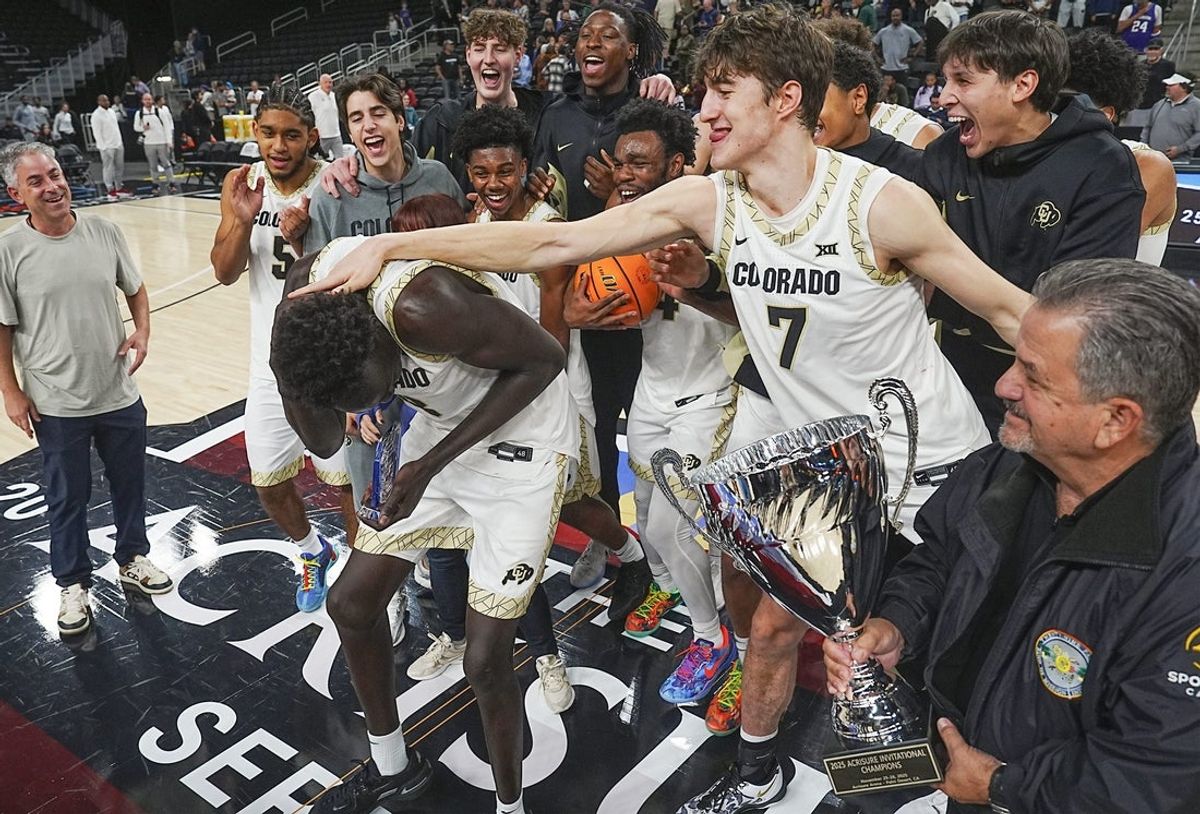 Bangot Dak, 8, is congratulated by teammates after receiving the mvp trophy for the Colorado Buffaloes after defeating Washington in the Acrisure Series Championship at Acrisure Arena in Palm Desert, Calif., Nov. 28, 2025.