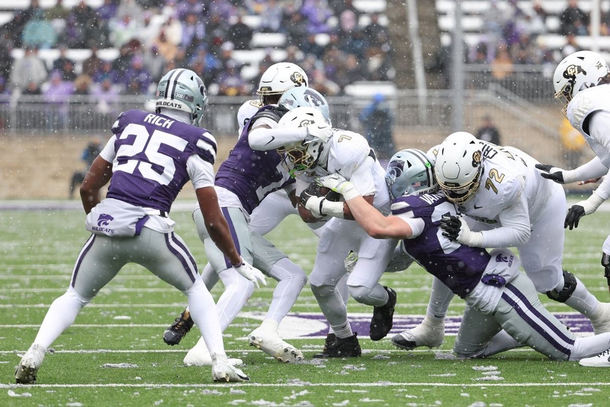 Nov 29, 2025; Manhattan, Kansas, USA; Colorado Buffaloes running back Dallan Hayden (7) is tackled by Kansas State Wildcats linebacker Rex Van Wyhe (28) and safety VJ Payne (7) during the first quarter at Bill Snyder Family Football Stadium. Mandatory Credit: Scott Sewell-Imagn Images