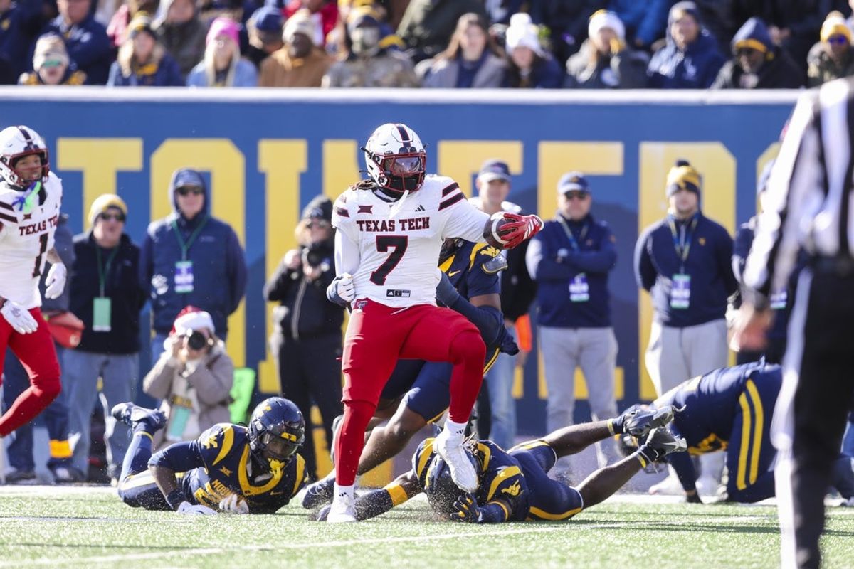 Nov 29, 2025; Morgantown, West Virginia, USA; Texas Tech Red Raiders tight end Terrance Carter Jr. (7) makes several West Virginia Mountaineers defenders miss after a catch during the first quarter at Milan Puskar Stadium. Mandatory Credit: Ben Queen-Imagn Images