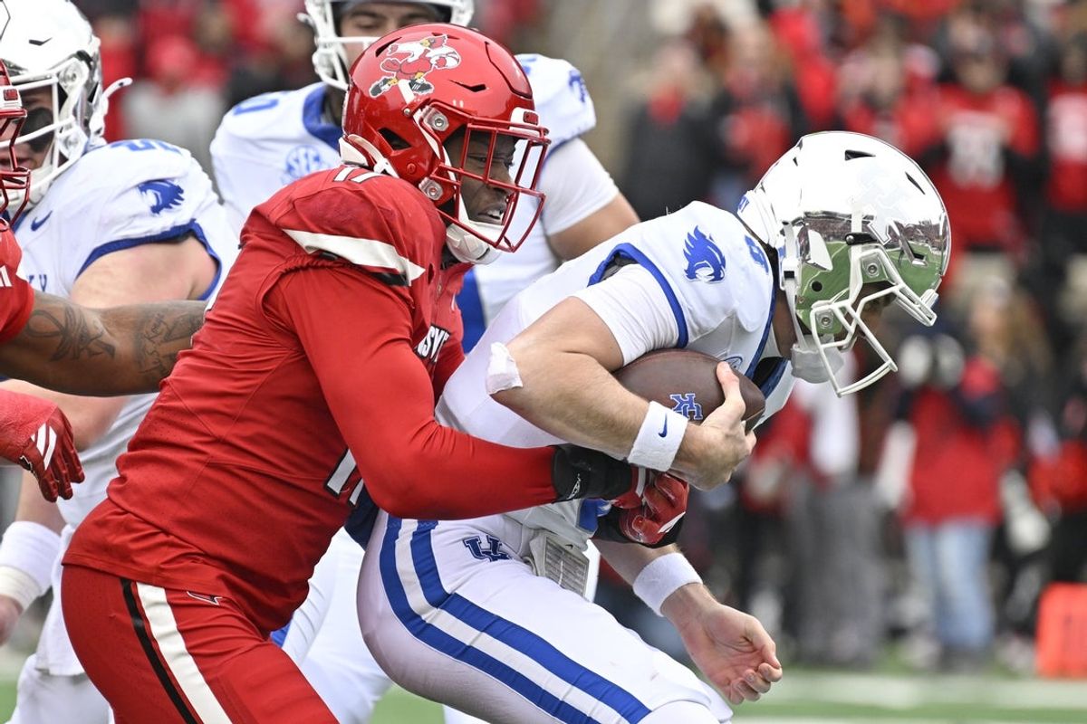 Nov 29, 2025; Louisville, Kentucky, USA;  Louisville Cardinals defensive lineman AJ Green (17) sacks Kentucky Wildcats quarterback Cutter Boley (8) during the first half at L&N Federal Credit Union Stadium. Mandatory Credit: Jamie Rhodes-Imagn Images