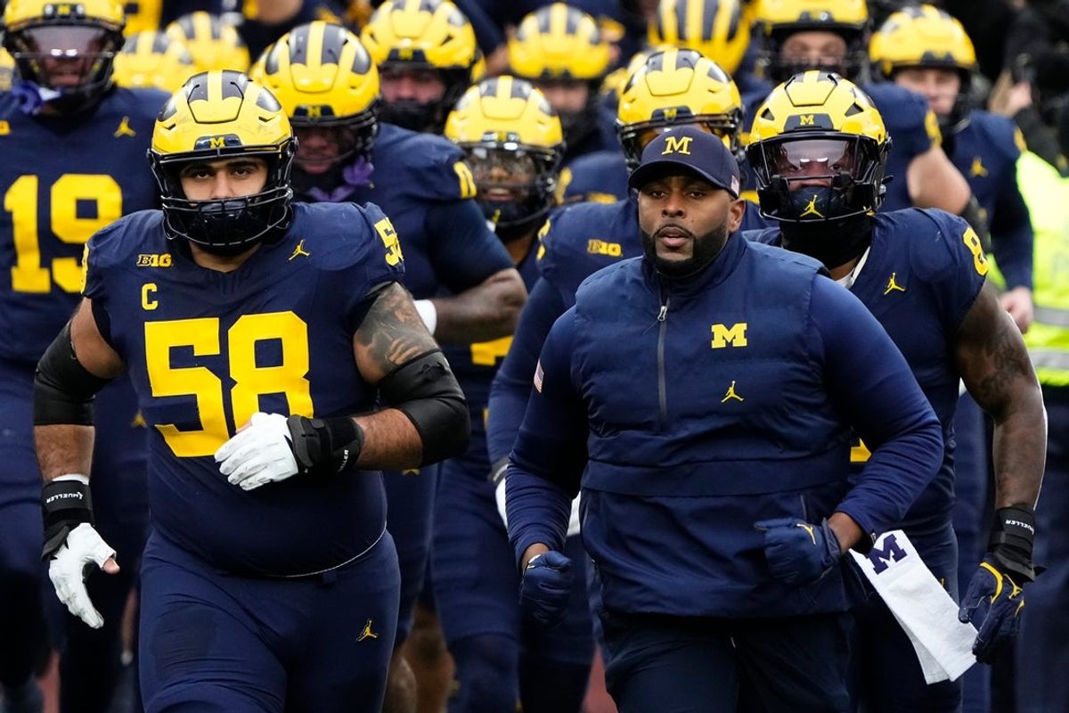 Then-Michigan Wolverines head coach Sherrone Moore leads his team onto the field prior to the NCAA football game against the Ohio State Buckeyes at Michigan Stadium in Ann Arbor, Mich. on Nov. 29, 2025.