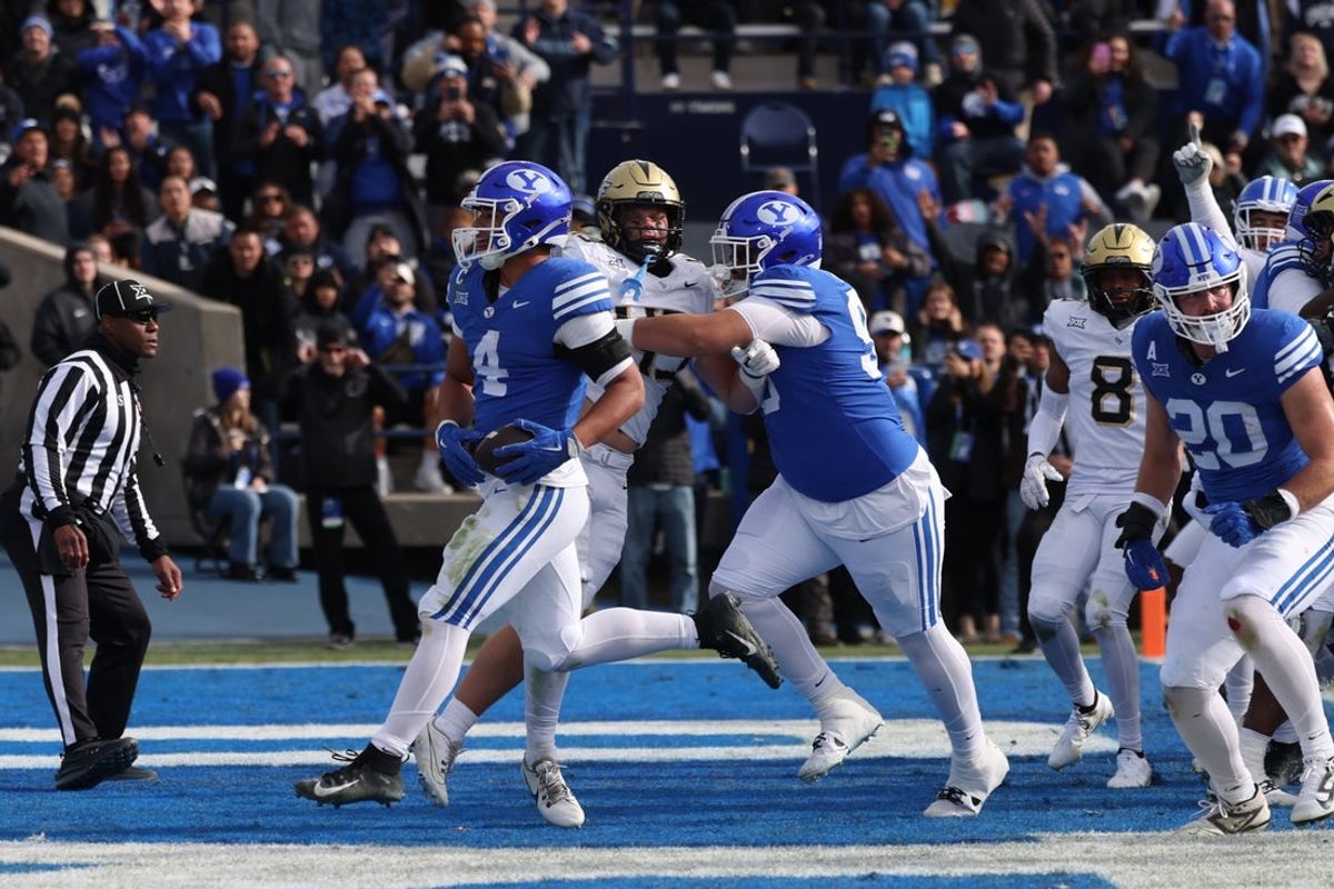 Nov 29, 2025; Provo, Utah, USA; BYU Cougars running back LJ Martin (4) runs for a touchdown against the UCF Knights during the second quarter at LaVell Edwards Stadium. Mandatory Credit: Rob Gray-Imagn Images