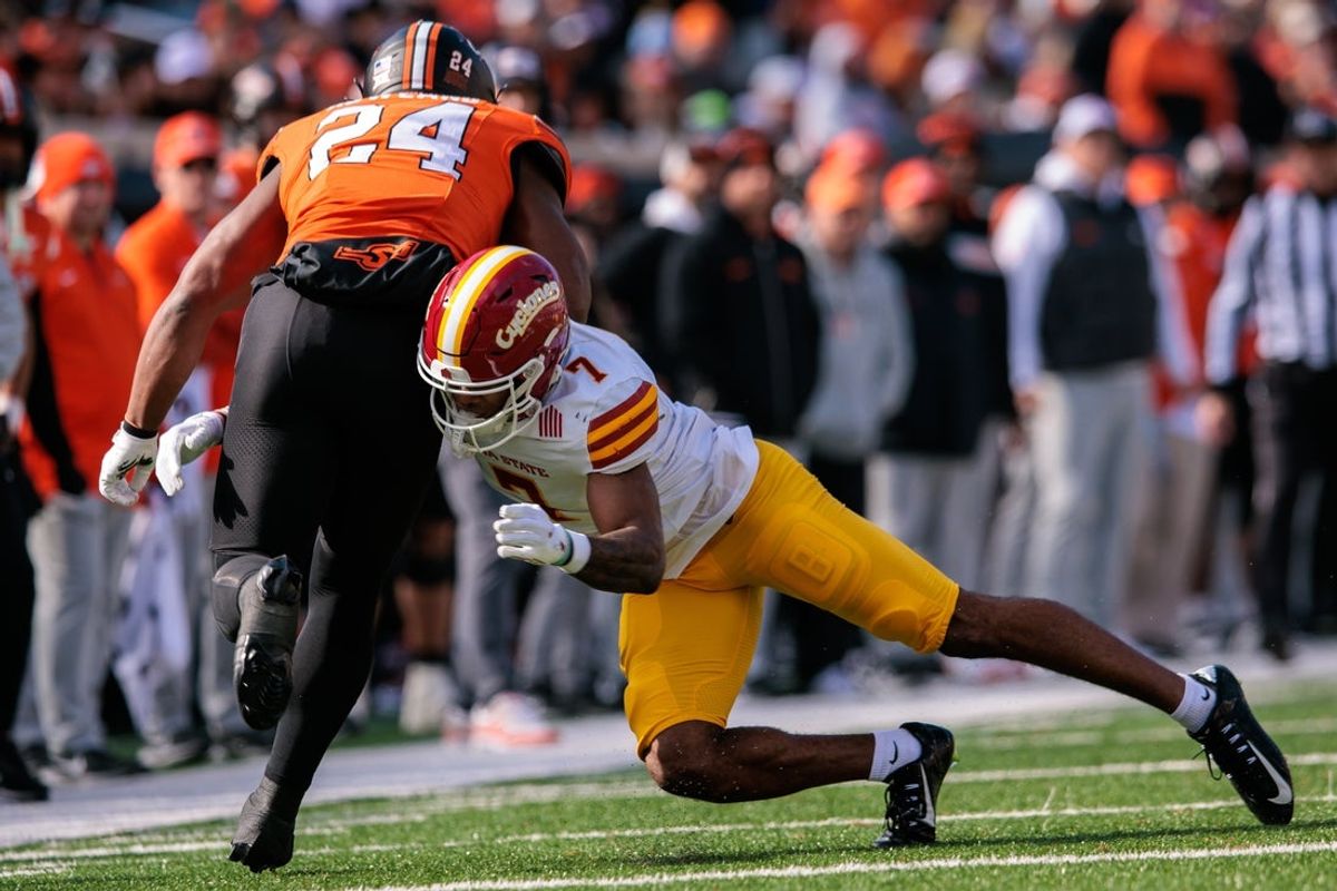 Nov 29, 2025; Stillwater, Oklahoma, USA; Iowa State Cyclones defensive back Tre Bell (7) tackles Oklahoma State Cowboys running back Trent Howland (24) at Boone Pickens Stadium. Mandatory Credit: William Purnell-Imagn Images