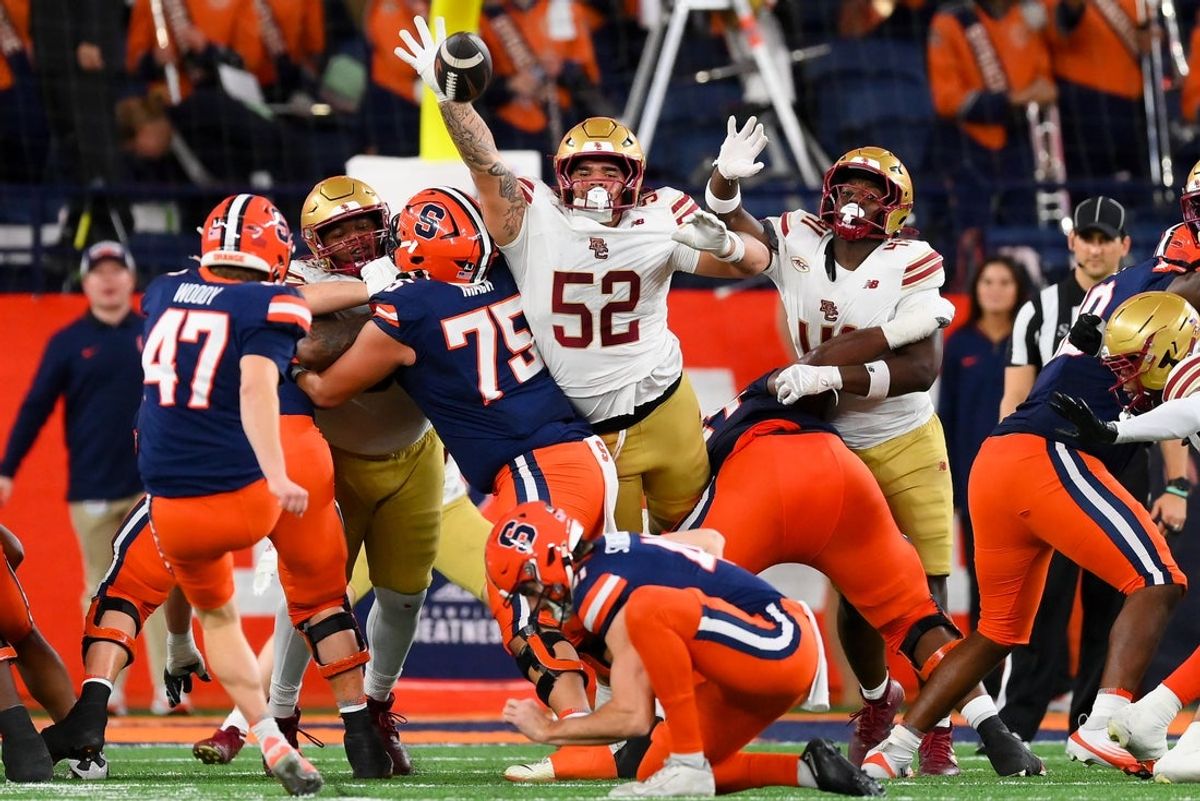 Nov 29, 2025; Syracuse, New York, USA; Boston College Eagles defensive lineman Chris Marable Jr. (52) attempts to block a field goal attempt by Syracuse Orange place kicker Tripp Woody (47) during the first half at the JMA Wireless Dome. Mandatory Credit: Rich Barnes-Imagn Images