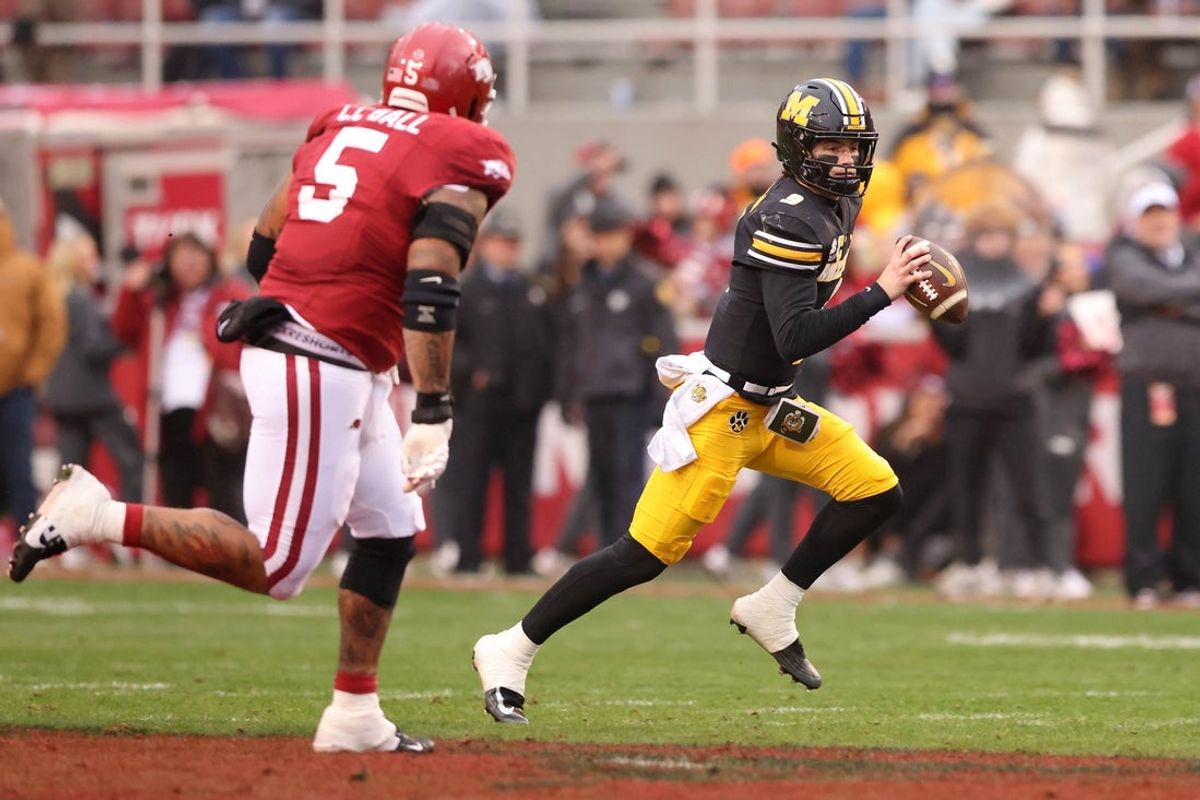 Nov 29, 2025; Fayetteville, Arkansas, USA; Missouri Tigers quarterback Beau Pribula (9) runs during the first quarter against the Arkansas Razorbacks at Donald W. Reynolds Razorback Stadium. Mandatory Credit: Nelson Chenault-Imagn Images