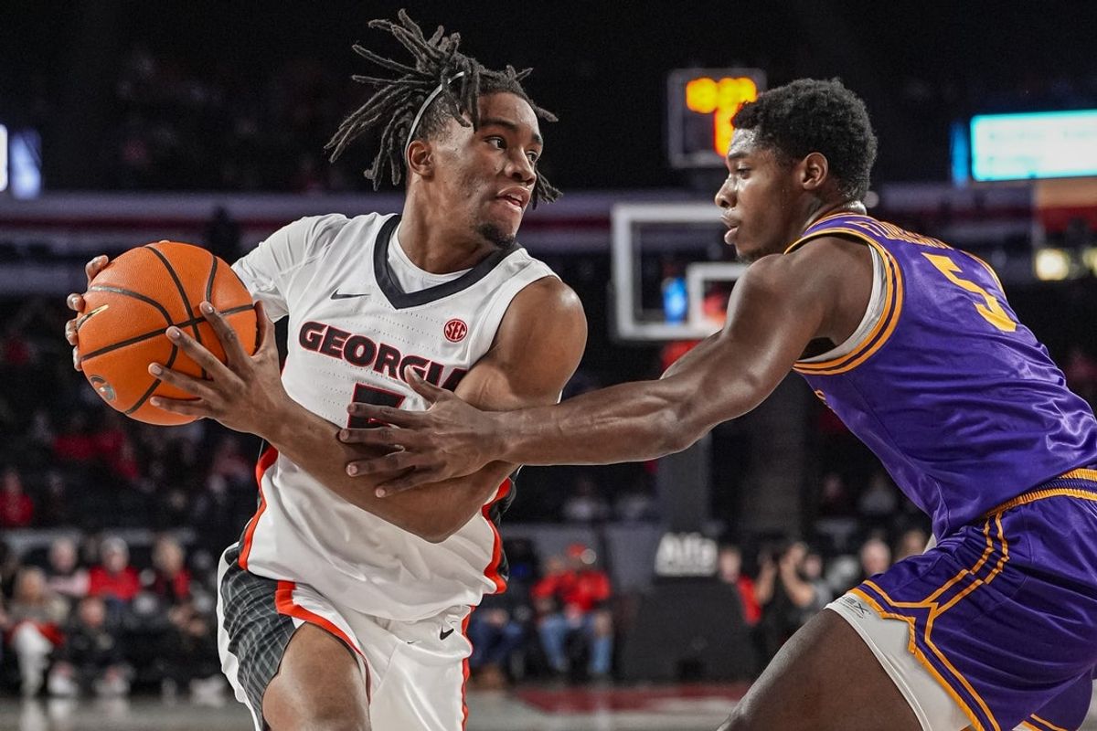 Nov 29, 2025; Athens, Georgia, USA; Georgia Bulldogs guard Jeremiah Wilkinson (5) protects the ball from Tennessee Tech Golden Eagles guard Ja'Quavian Florence (5) during the first half at Stegeman Coliseum. Mandatory Credit: Dale Zanine-Imagn Images