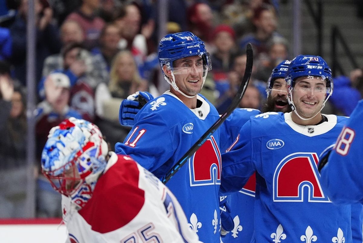 Nov 29, 2025; Denver, Colorado, USA; Colorado Avalanche center Brock Nelson (11) celebrates his hat trick goal with center Ross Colton (20) in the second period against the Montreal Canadiens at Ball Arena. Mandatory Credit: Ron Chenoy-Imagn Images